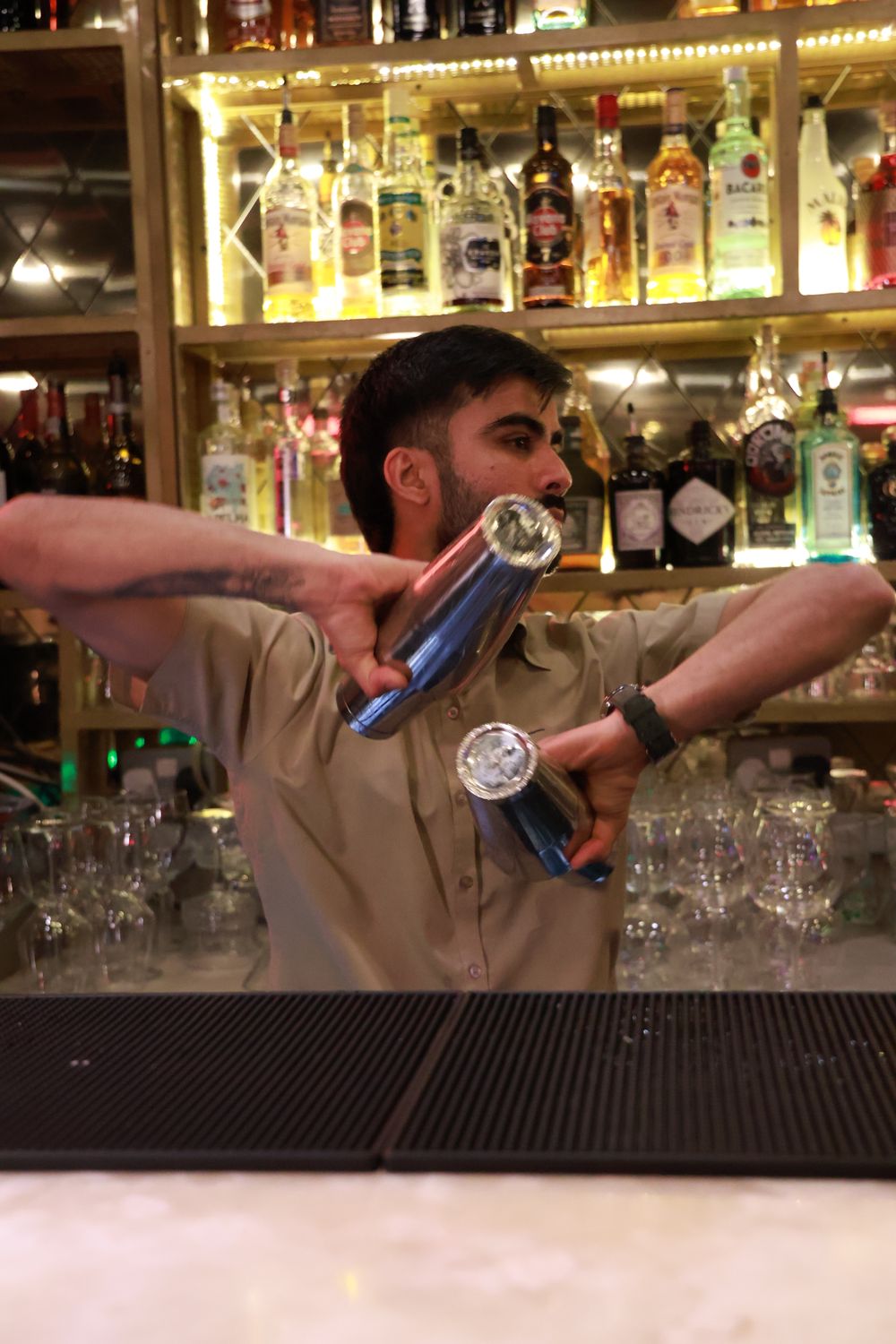 A bartender shaking a cocktail