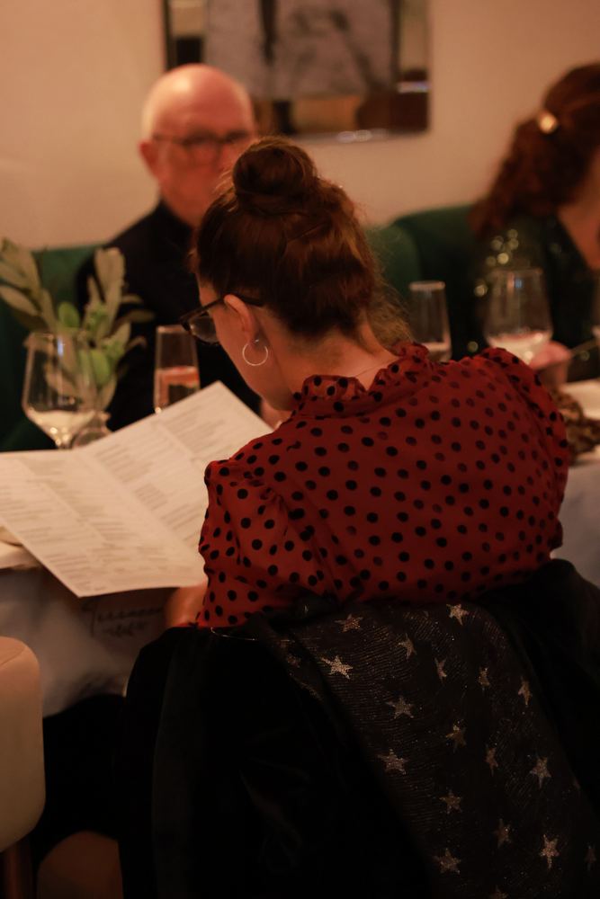 Guests reading the menu in the dining room