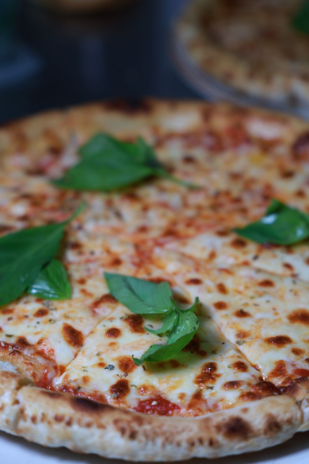 Pizza with melted cheese and basil