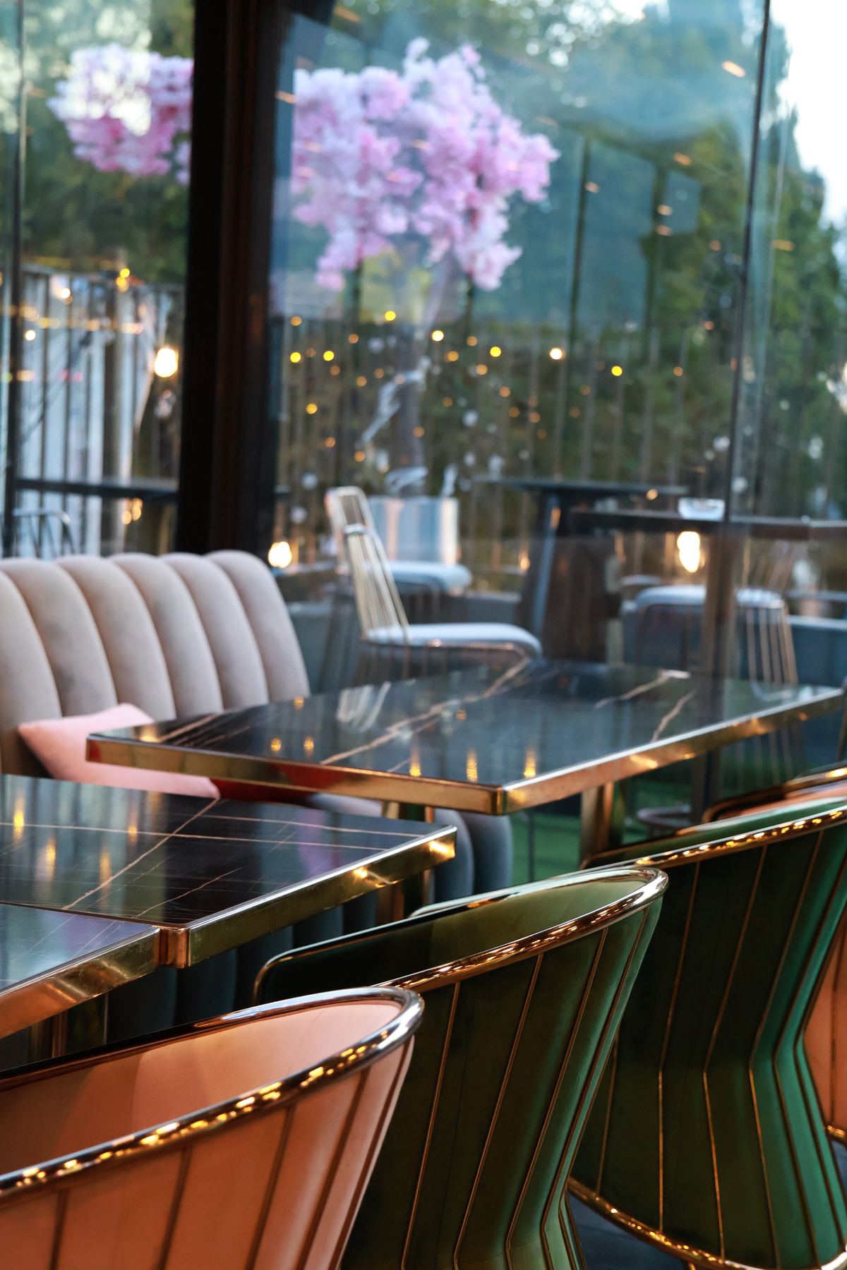 The rooftop with pink blossom and velvet chairs