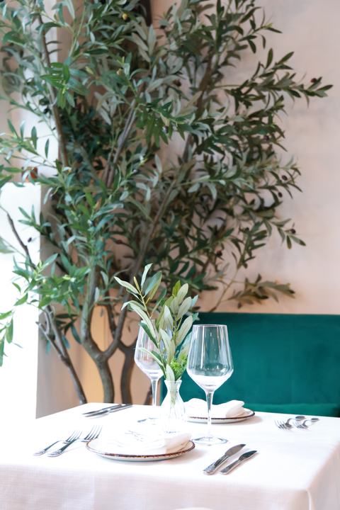 Olive trees and white linen by the window