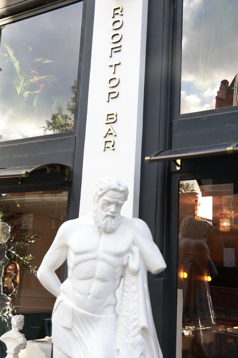 Our statue by the Rooftop Bar sign